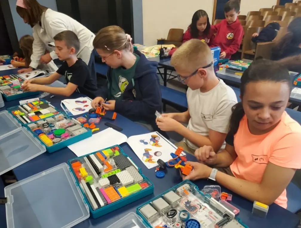 Students building colorful robotics projects together